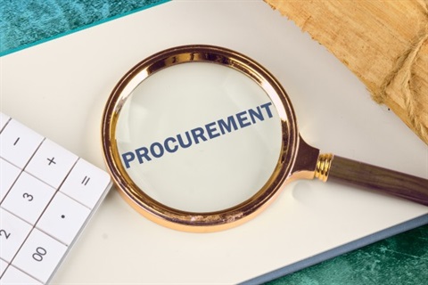 A photo of a document labelled Procurement, seen through a magnifying glass